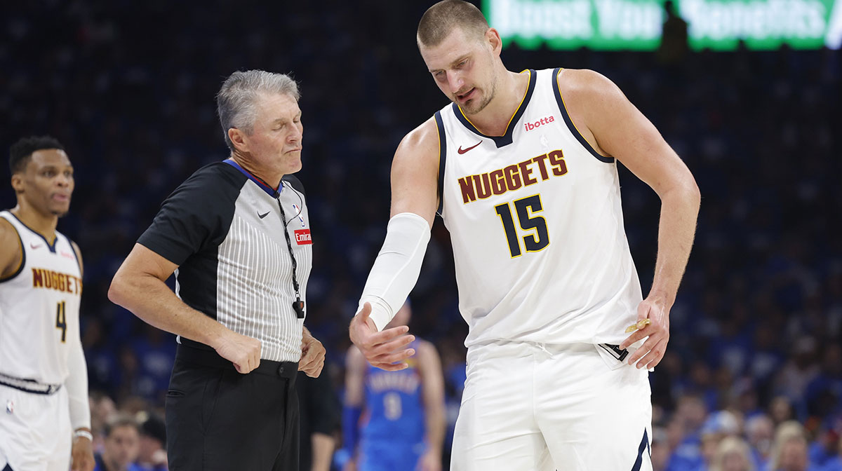 Denver Nuggets center Nikola Jokic (15) talks to an official during a break in play against the Oklahoma City Thunder in the second quarter during game seven of the second round for the 2025 NBA Playoffs at Paycom Center.
