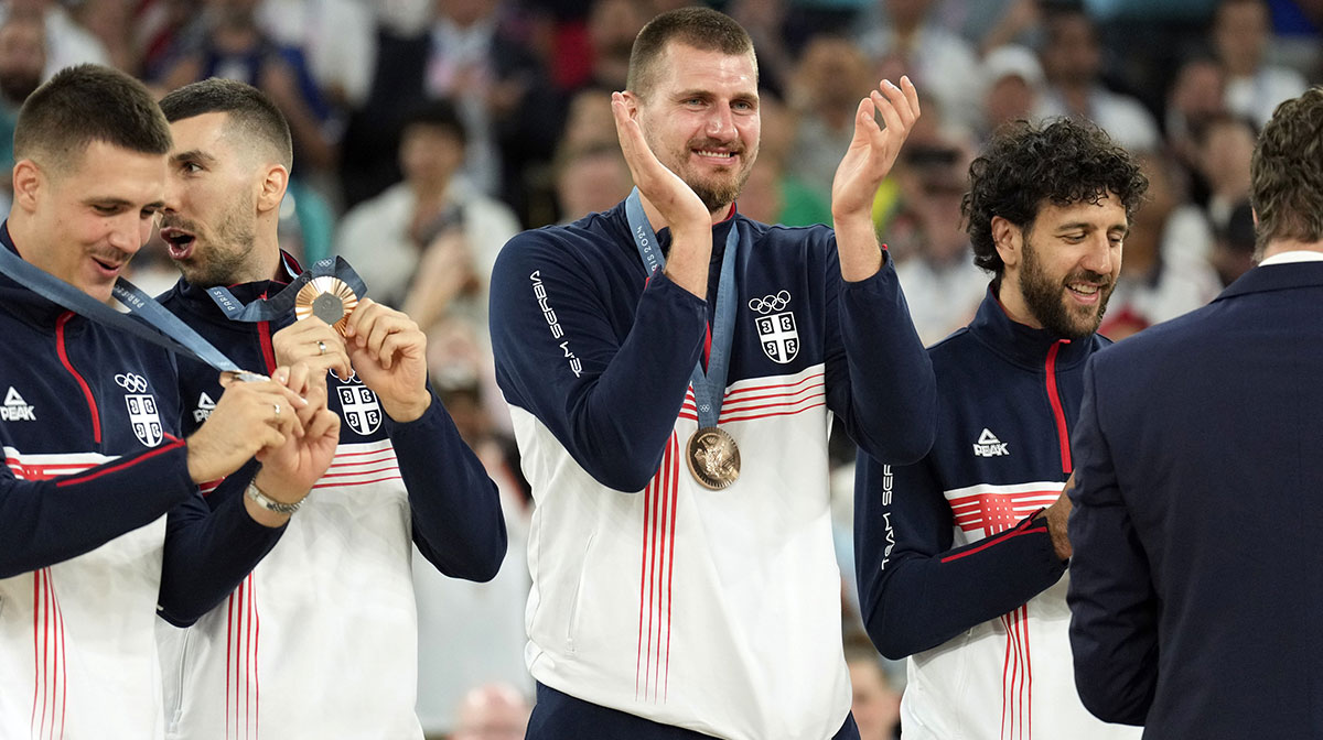Serbia and Denver Nuggets power forward Nikola Jokic (15) celebrates on the podium with teammates after winning the bronze medal in men's basketball during the Paris 2024 Olympic Summer Games at Accor Arena.