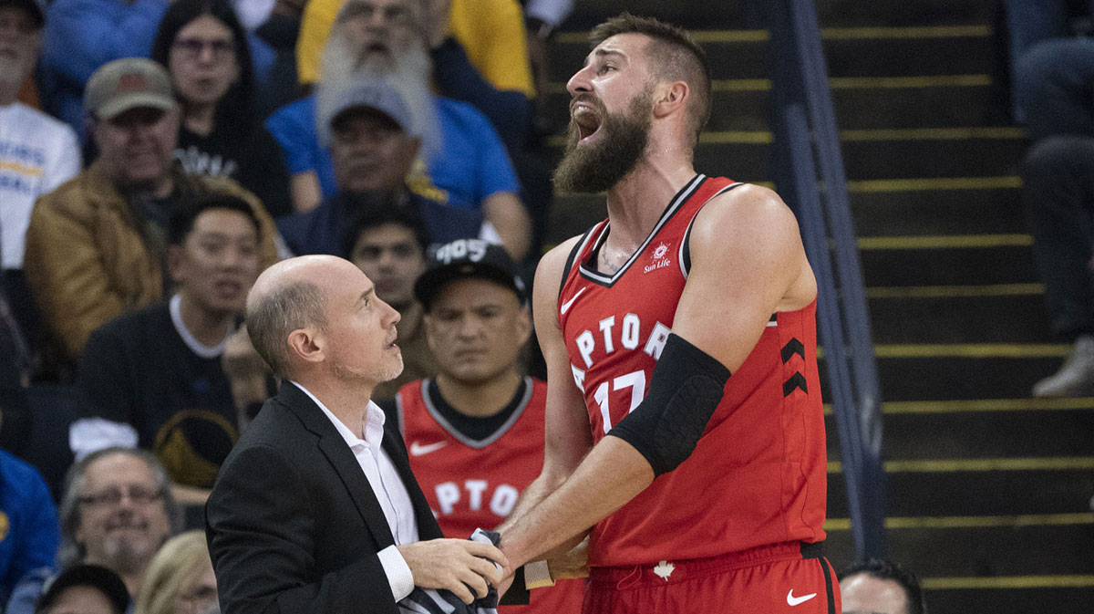 Toronto Raptors center Jonas Valanciunas (17) reacts after an injury against the Golden State Warriors during the first quarter at Oracle Arena.
