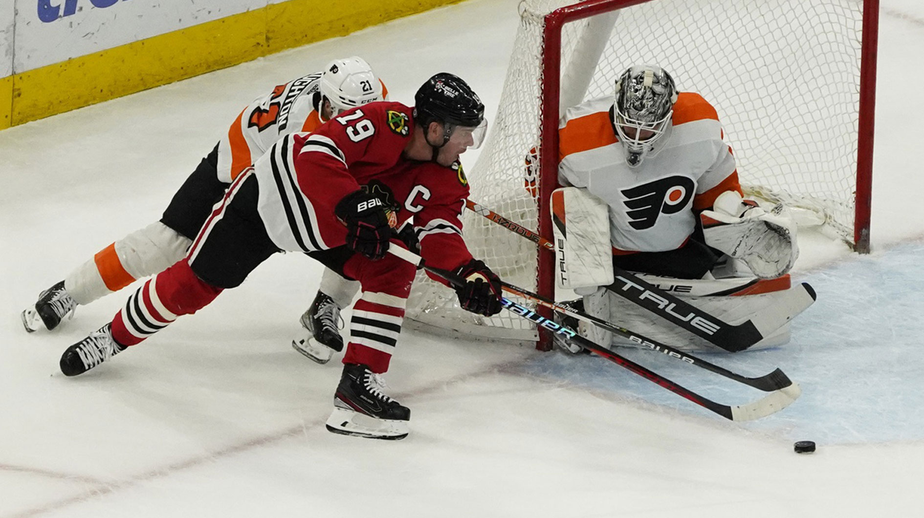 Philadelphia Flyers goaltender Felix Sandstrom (32) makes a save on Chicago Blackhawks center Jonathan Toews (19) during the first period at United Center.