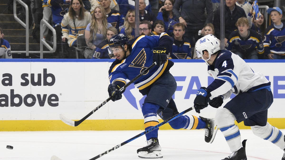 St. Louis Blues right wing Jordan Kyrou (25) shoots against Winnipeg Jets defenseman Neal Pionk (4) during the second period in game four of the first round of the 2025 Stanley Cup Playoffs at Enterprise Center.