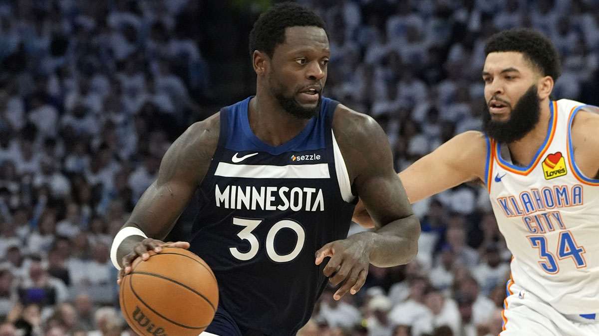 Minnesota Timberwolves forward Julius Randle (30) dribbles the ball against Oklahoma City Thunder forward Kenrich Williams (34) during the second half in game three of the western conference finals for the 2025 NBA Playoffs at Target Center.