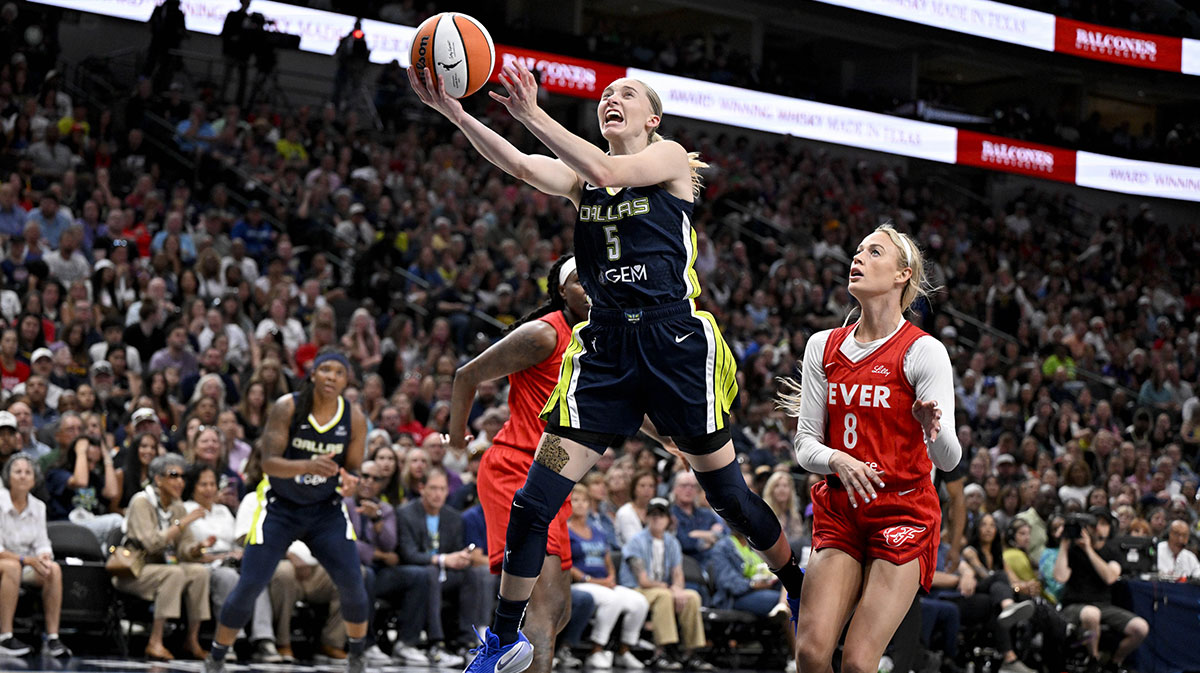 Dallas Wings guard Paige Bueckers (5) drives to the basket past Indiana Fever guard Sophie Cunningham (8) during the second quarter at the American Airlines Center.