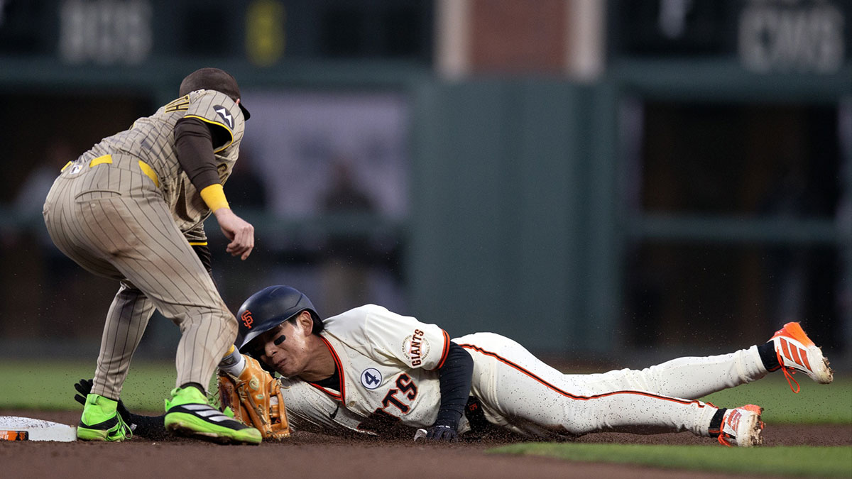 San Francisco Giants center fielder Jung Hoo Lee (51) slides safely past San Diego Padres second baseman Jake Cronenworth (9) with a stolen base during the sixth inning at Oracle Park.