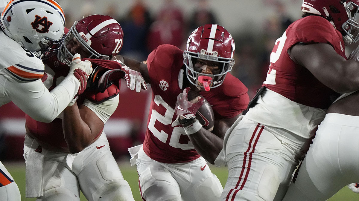 Alabama Crimson Tide running back Justice Haynes (22) runs behind offensive lineman Parker Brailsford (72) and offensive lineman Tyler Booker (52) against the Auburn Tigers during the second half at Bryant-Denny Stadium. Alabama won 28-14.