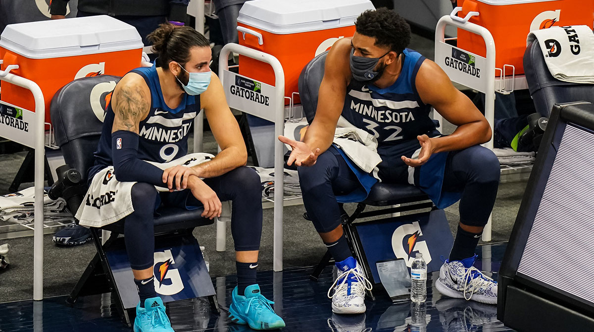 Minnesota Timberwolves guard Ricky Rubio (9) talks with center Karl-Anthony Towns (32) during the first quarter against the Detroit Pistons at Target Center.