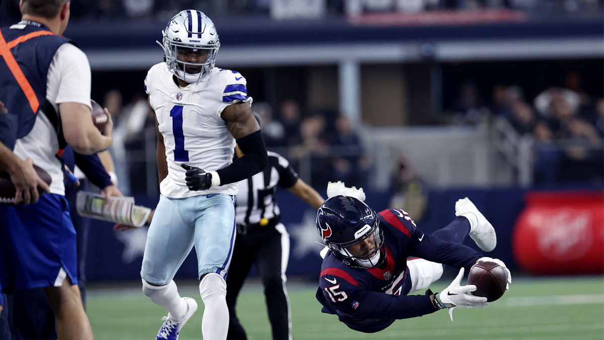 Houston Texans wide receiver Chris Moore (15) dives for yardage in front of Dallas Cowboys cornerback Kelvin Joseph (1) during the second half at AT&T Stadium.