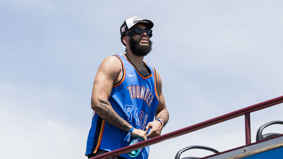 Oklahoma City Thunder player Kenrich Williams opens a bottle to celebrate during the 2025 NBA Oklahoma City Thunder championship parade.