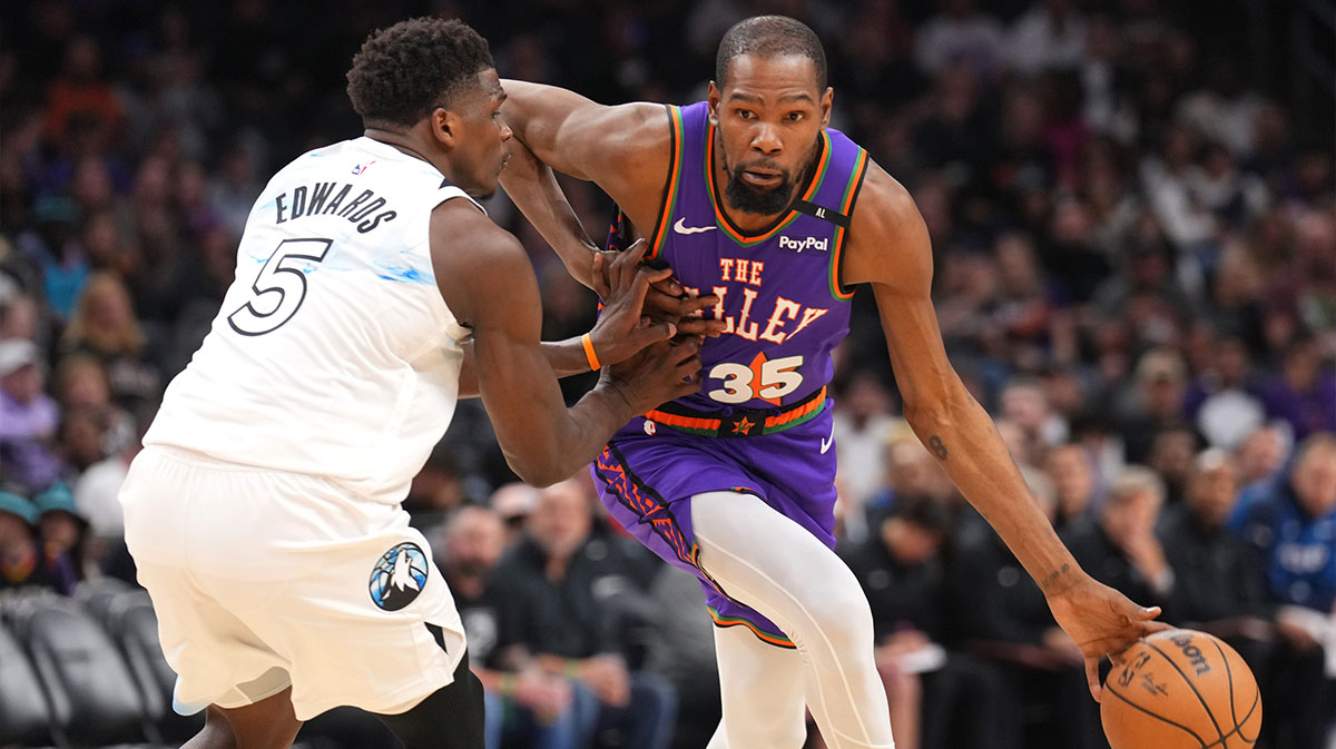 Phoenix Suns forward Kevin Durant (35) dribbles against Minnesota Timberwolves guard Anthony Edwards (5) during the second half at Footprint Center.