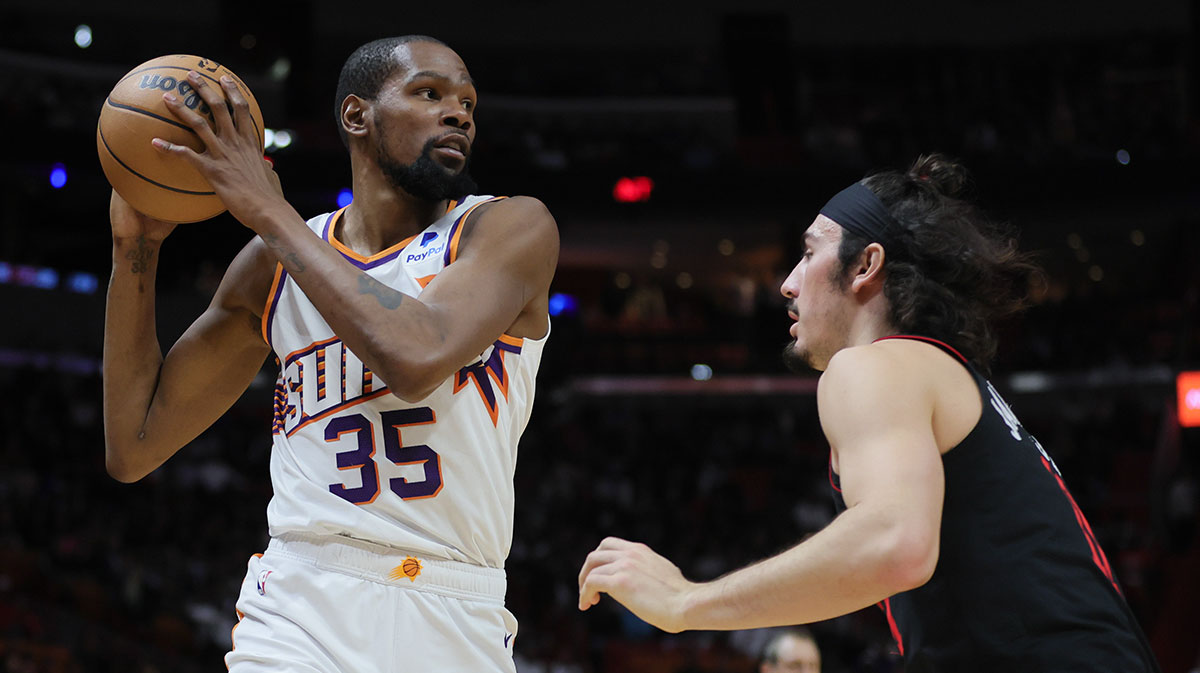 Phoenix Suns forward Kevin Durant (35) protects the basketball from Miami Heat guard Jaime Jaquez Jr. (11) during the second quarter at Kaseya Center.