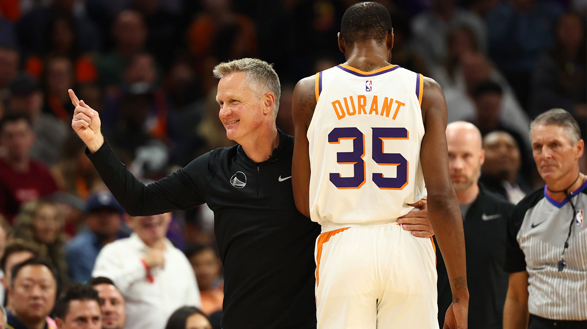 Phoenix Suns forward Kevin Durant (35) with Golden State Warriors head coach Steve Kerr in the first half at Footprint Center.