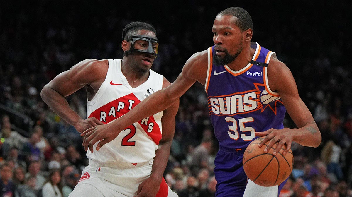 Phoenix Suns forward Kevin Durant (35) shields the ball from Toronto Raptors forward Jonathan Mogbo (2) in the second half at Footprint Center.