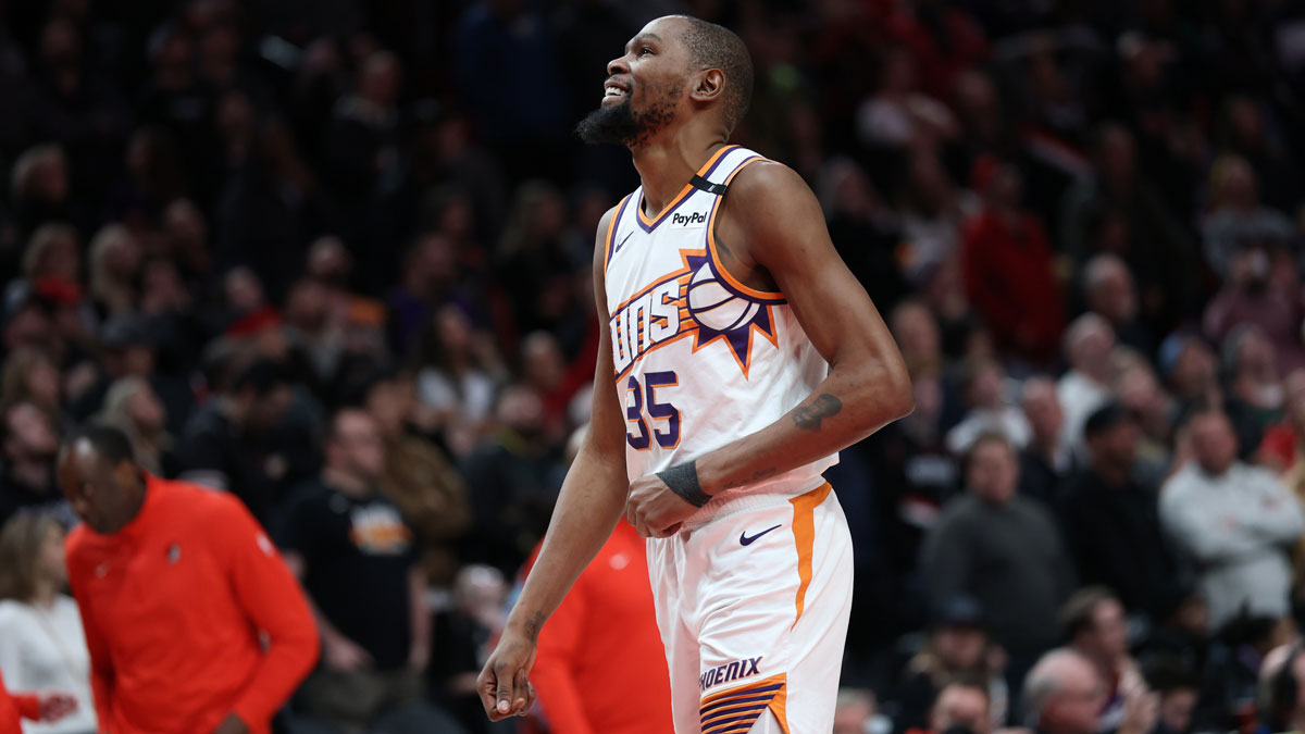 Phoenix Suns forward Kevin Durant (35) laughs as he watches a replay of his teammate Suns’ guard Devin Booker (1) being fouled by Portland Trail Blazers forward Deni Avdija (8) in overtime at Moda Center.