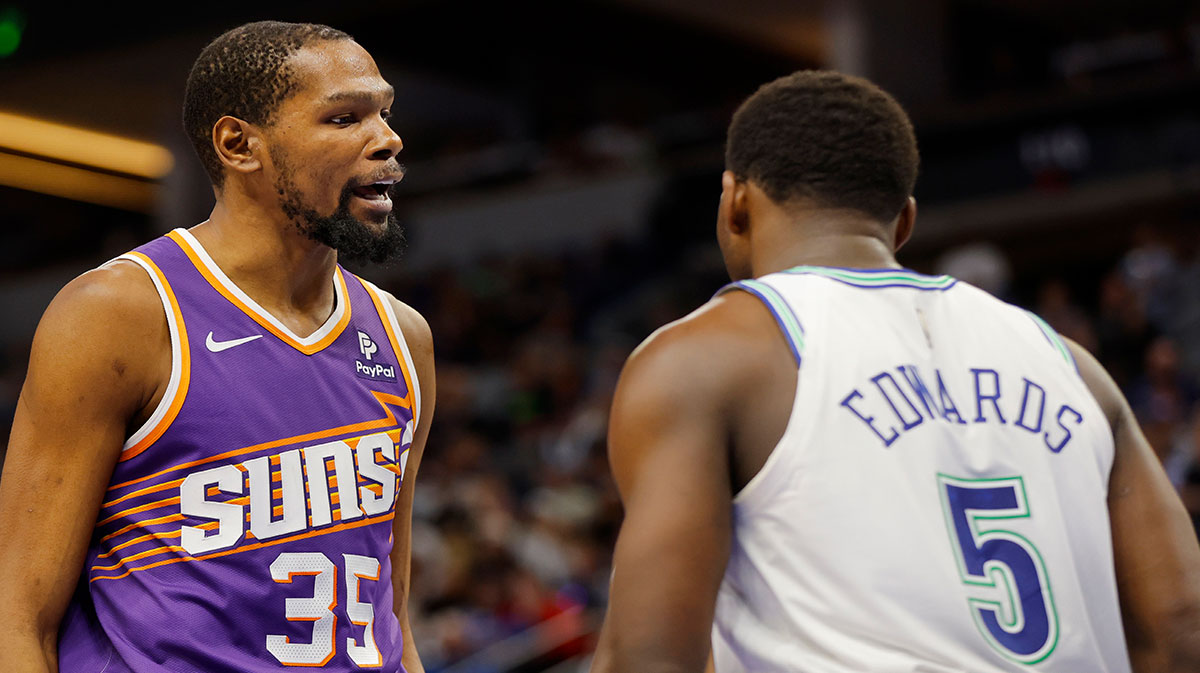 Phoenix Suns forward Kevin Durant (35) shares words with Minnesota Timberwolves guard Anthony Edwards (5) after fouling him in the third quarter at Target Center.