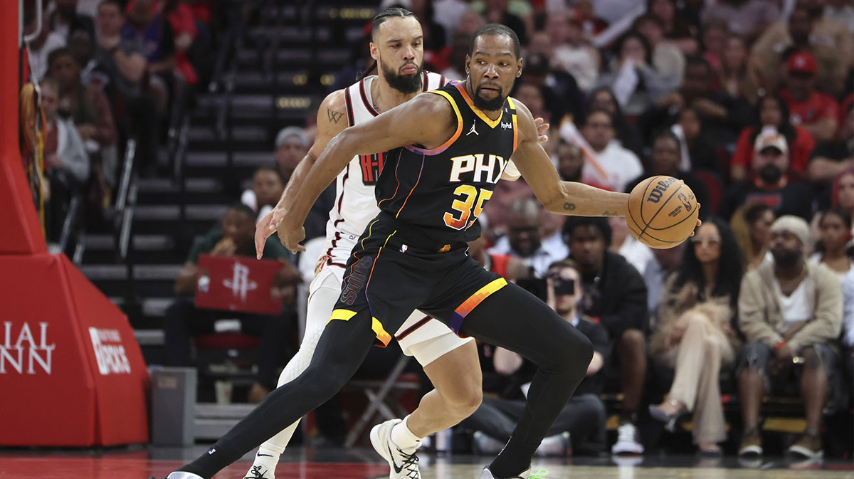 Phoenix Suns forward Kevin Durant (35) controls the ball as Houston Rockets forward Dillon Brooks (9) defends during the third quarter at Toyota Center.