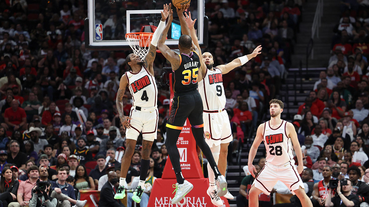 Houston Rockets guard Jalen Green (4) and forward Dillon Brooks (9) defend against Phoenix Suns forward Kevin Durant (35) during the third quarter at Toyota Center.