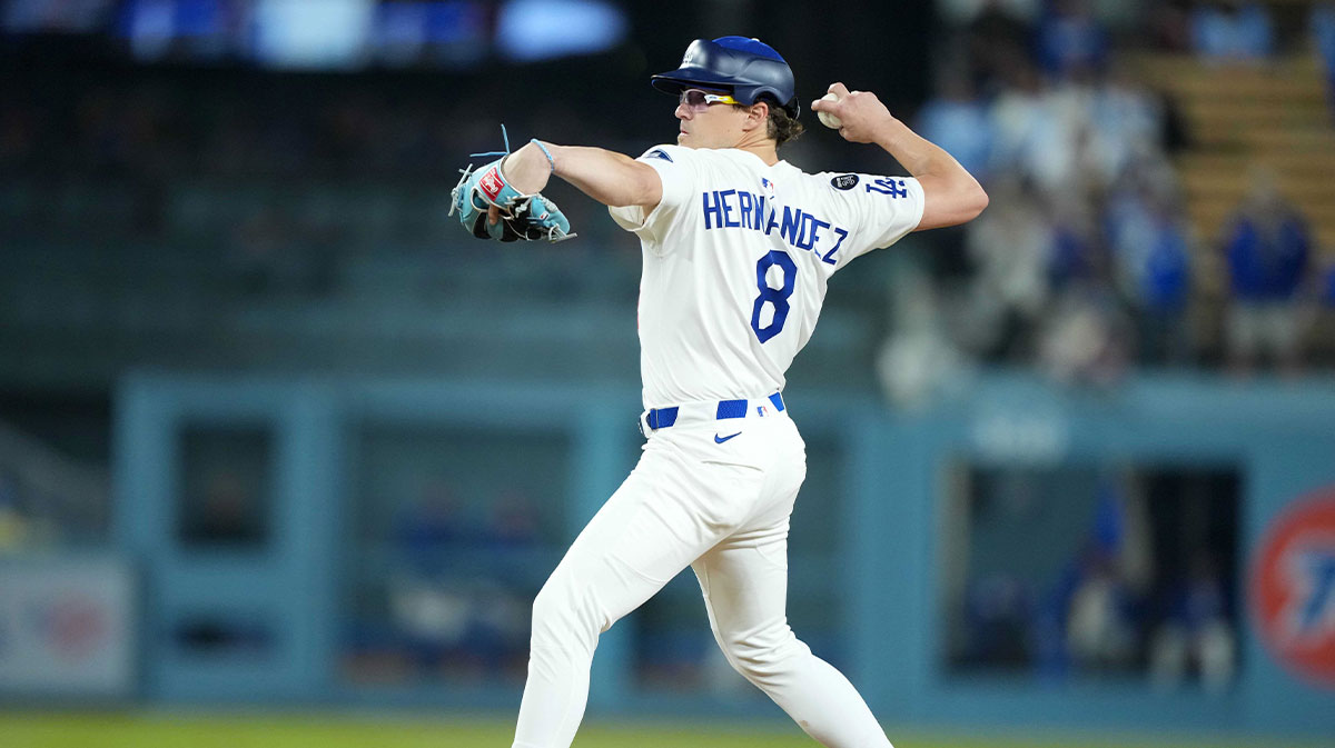 Apr 29, 2025; Los Angeles, California, USA; Los Angeles Dodgers first baseman Kike Hernandez (8) pitches in the ninth inning against the Miami Marlins to first player to wear approved pitcher hybrid helmet/cap in a game at Dodger Stadium.