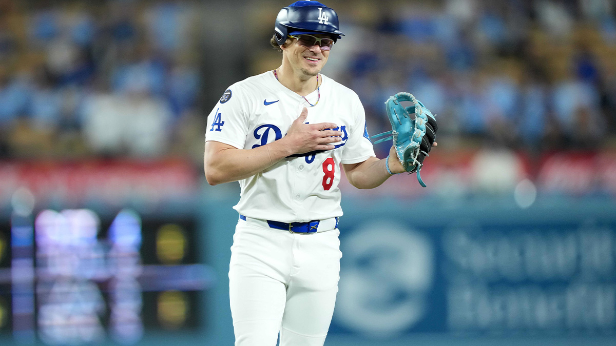 Los Angeles Dodgers first baseman Kike Hernandez (8) pitches in the ninth inning against the Miami Marlins to first player to wear approved pitcher hybrid helmet/cap in a game at Dodger Stadium.