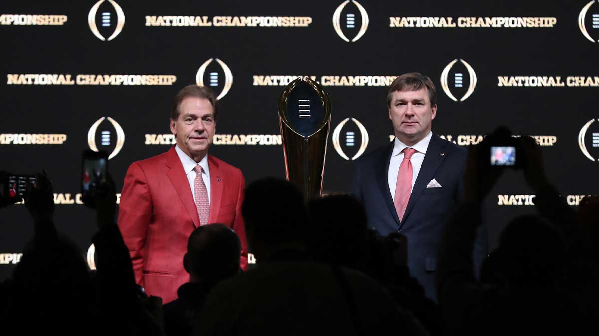 Photographers take pictures of Alabama Crimson Tide head coach Nick Saban as he poses for a photo with Georgia Bulldogs head coach Kirby Smart and College Football Playoff National Championship Trophy at Sheraton Atlanta.