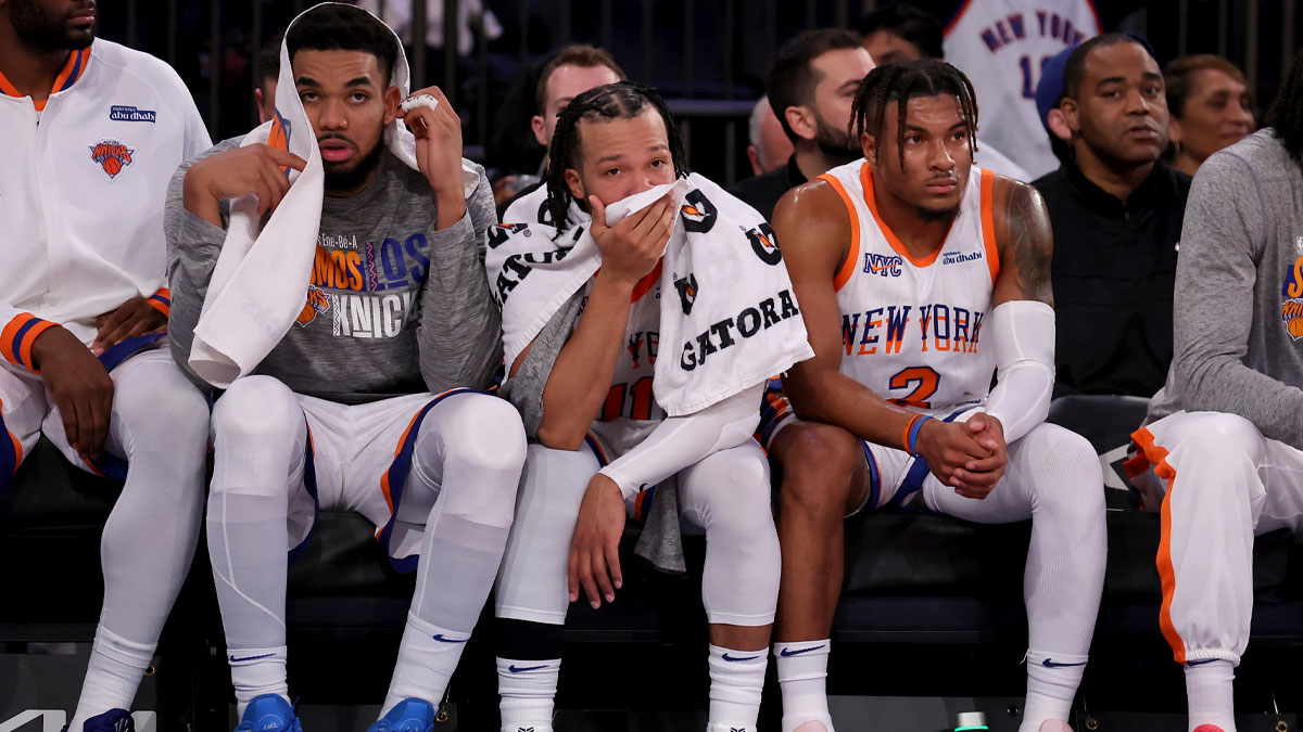 New York Knicks center Karl-Anthony Towns (32) and guards Jalen Brunson (11) and Miles McBride (2) watch from the bench during the fourth quarter against the Oklahoma City Thunder at Madison Square Garden.