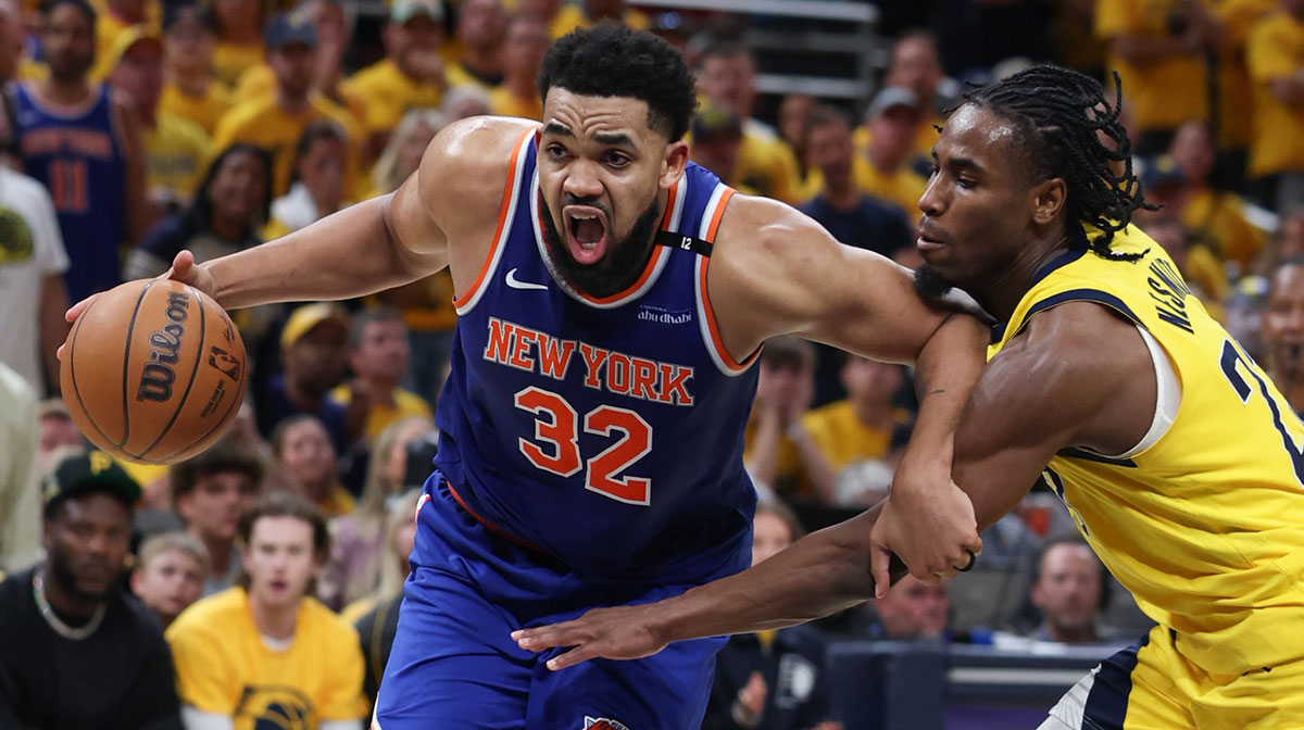 New York Knicks center Karl-Anthony Towns (32) drives to the basket against Indiana Pacers guard Andrew Nembhard (2) in the third quarter during game six of the eastern conference finals for the 2025 NBA Playoffs at Gainbridge Fieldhouse.