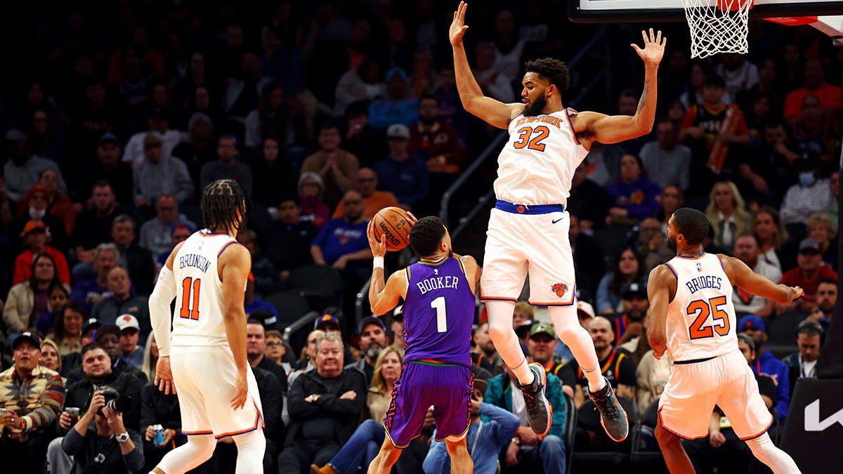 Phoenix Suns guard Devin Booker (1) shoots the ball against New York Knicks center Karl-Anthony Towns (32) during the third quarter at Footprint Center.