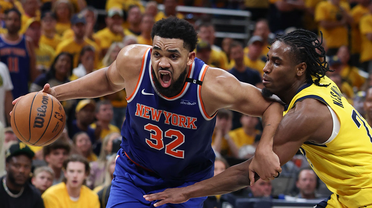 Knicks center Karl-Anthony Towns (32) drives to the basket against Indiana Pacers guard Andrew Nembhard (2) in the third quarter during game six of the eastern conference finals for the 2025 NBA Playoffs at Gainbridge Fieldhouse