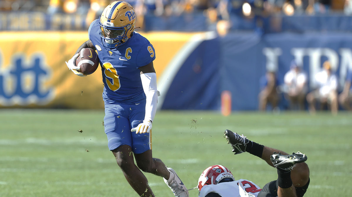 Pittsburgh Panthers wide receiver Konata Mumpfield (9) steps out of a tackle attempt by Youngstown State Penguins defensive back Isaiah Hackett (2) after a catch during the first quarter at Acrisure Stadium.
