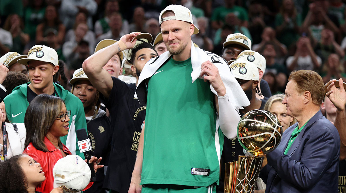 Boston Celtics center Kristaps Porzingis (8) celebrates after winning the 2024 NBA Finals against the Dallas Mavericks at TD Garden.