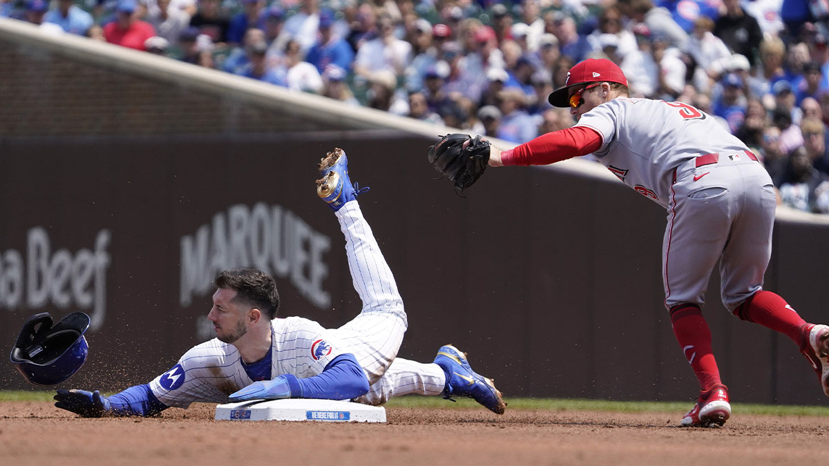 Cincinnati Reds second base Matt McLain (9) tags out Chicago Cubs outfielder Kyle Tucker (30) on a steal attempt of second base during the first inning at Wrigley Field.