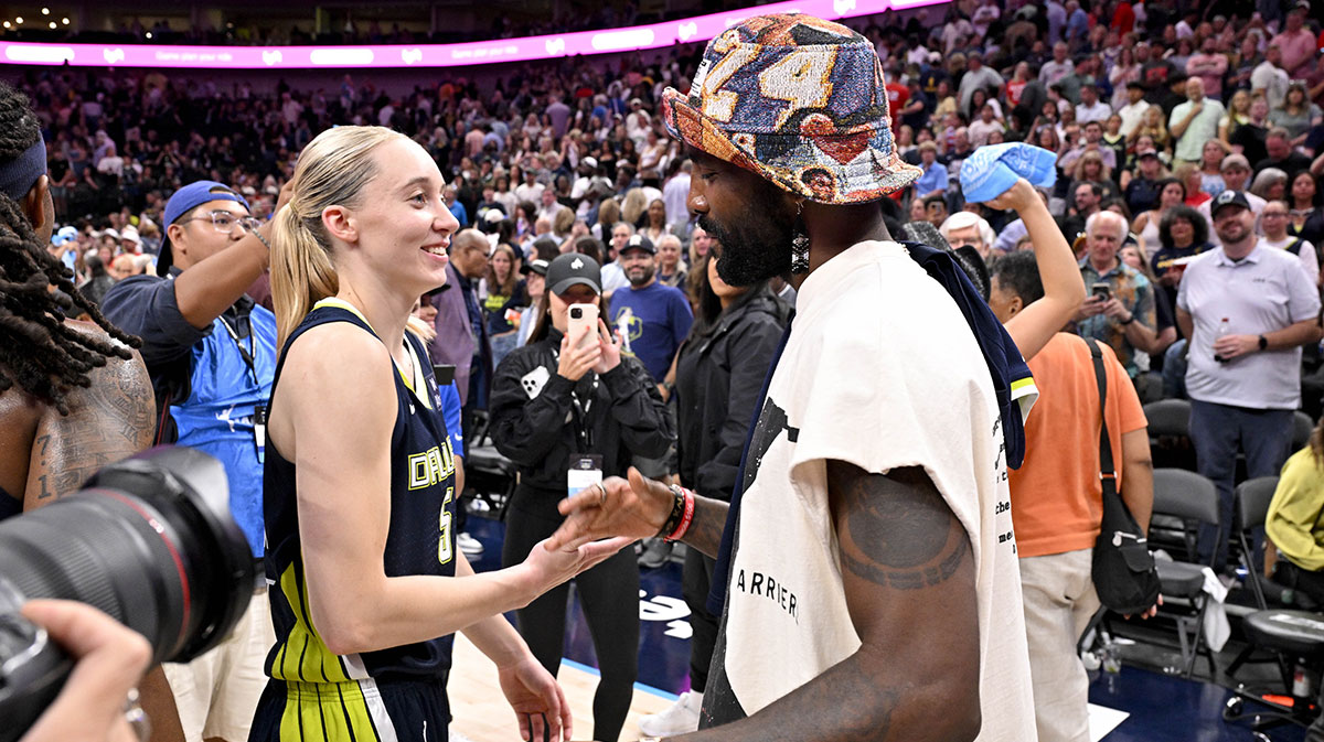 Dallas Mavericks point guard Kyrie Irving talks with Dallas Wings guard Paige Bueckers (5) after the game against the Indiana Fever at the American Airlines Center.