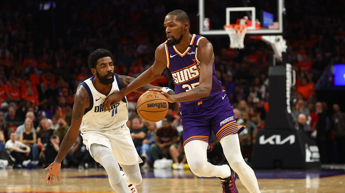 Phoenix Suns forward Kevin Durant (35) against Dallas Mavericks guard Kyrie Irving (11) in the first half of the home opener at Footprint Center.