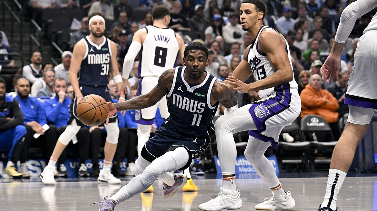Dallas Mavericks guard Kyrie Irving (11) drives to the basket past Sacramento Kings forward Keegan Murray (13) during the first quarter at the American Airlines Center.