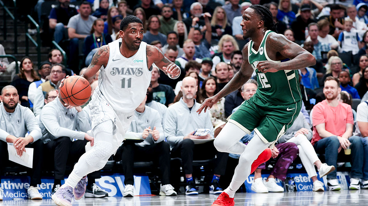Dallas Mavericks guard Kyrie Irving (11) dribbles as Milwaukee Bucks forward Taurean Prince (12) defends during the first half at American Airlines Center.