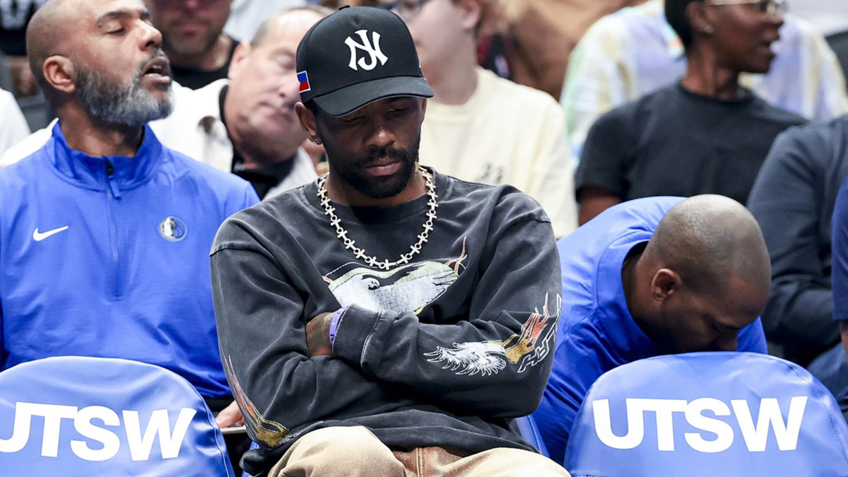 Dallas Mavericks guard Kyrie Irving sits on the bench against the Philadelphia 76ers during the first half.
