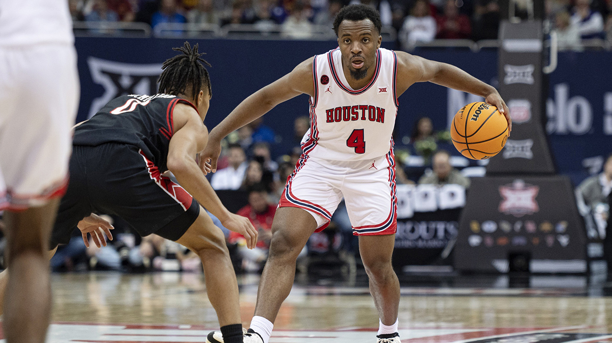 Houston Cougars guard LJ Cryer (4) controls the ball while defended by Texas Tech Red Raiders guard Chance McMillian (0) in the second half at T-Mobile Center.