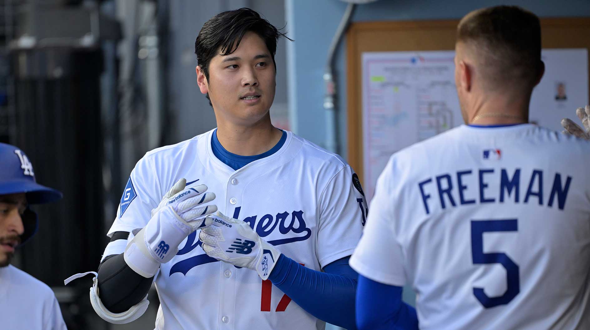 Jun 19, 2025; Los Angeles, California, USA; Los Angeles Dodgers two-way player Shohei Ohtani (17) with first base Freddie Freeman (5) during the first inning against the San Diego Padres at Dodger Stadium. Mandatory Credit: Jayne Kamin-Oncea-Imagn Images