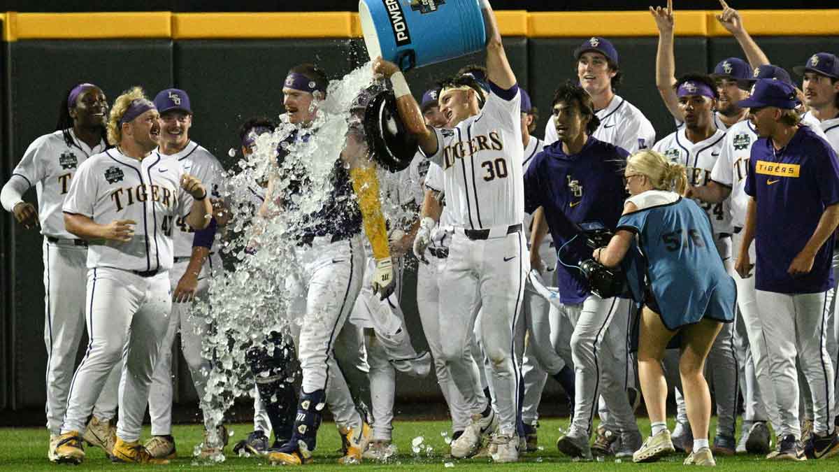 LSU Tigers first baseman Jared Jones (22) receives a Powerade Bath from catcher Edward Yamin IV (30) after hitting the game winning run against the Arkansas Razorbacks at Charles Schwab Field.