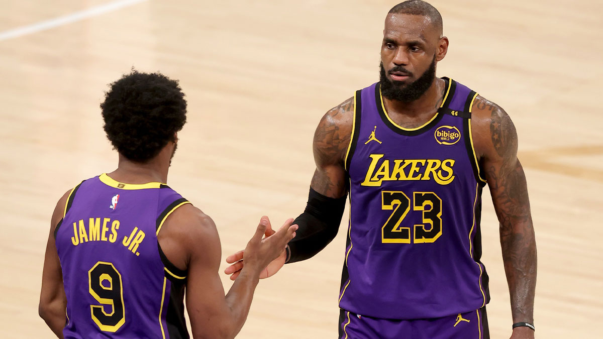 Lakers guard Bronny James (9) checks in for forward LeBron James (23) during the fourth quarter against the New York Knicks at Madison Square Garden