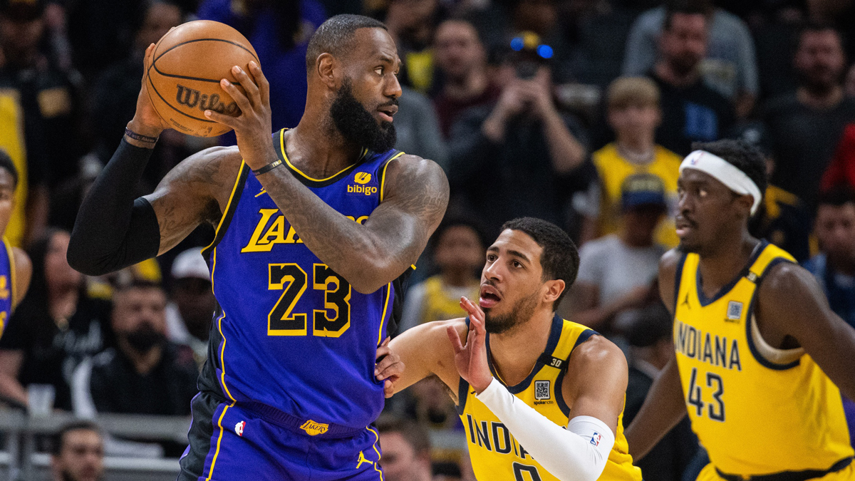 Los Angeles Lakers forward LeBron James (23) holds the ball while Indiana Pacers guard Tyrese Haliburton (0) defends in the first half at Gainbridge Fieldhouse.