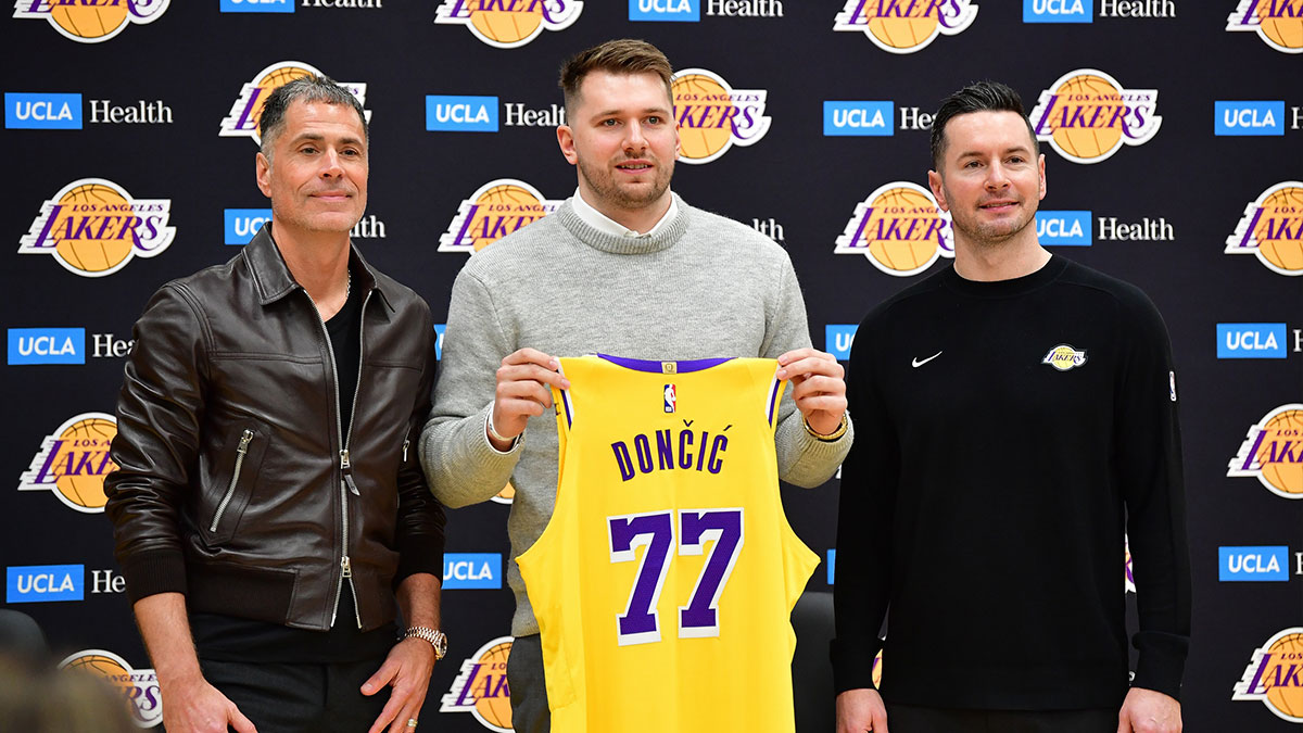 Los Angeles Lakers guard Luka Doncic poses for photos with general manager Rob Pelinka and head coach JJ Redick at UCLA Health Training Center.