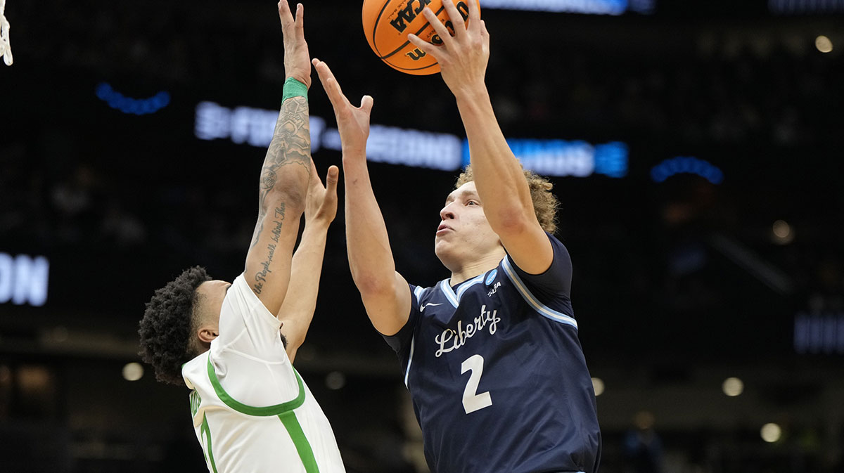 Liberty Flames guard Taelon Peter (2) shoots the ball over Oregon Ducks guard Ra'Heim Moss (0) during the second half in the first round of the NCAA Tournament at Climate Pledge Arena.