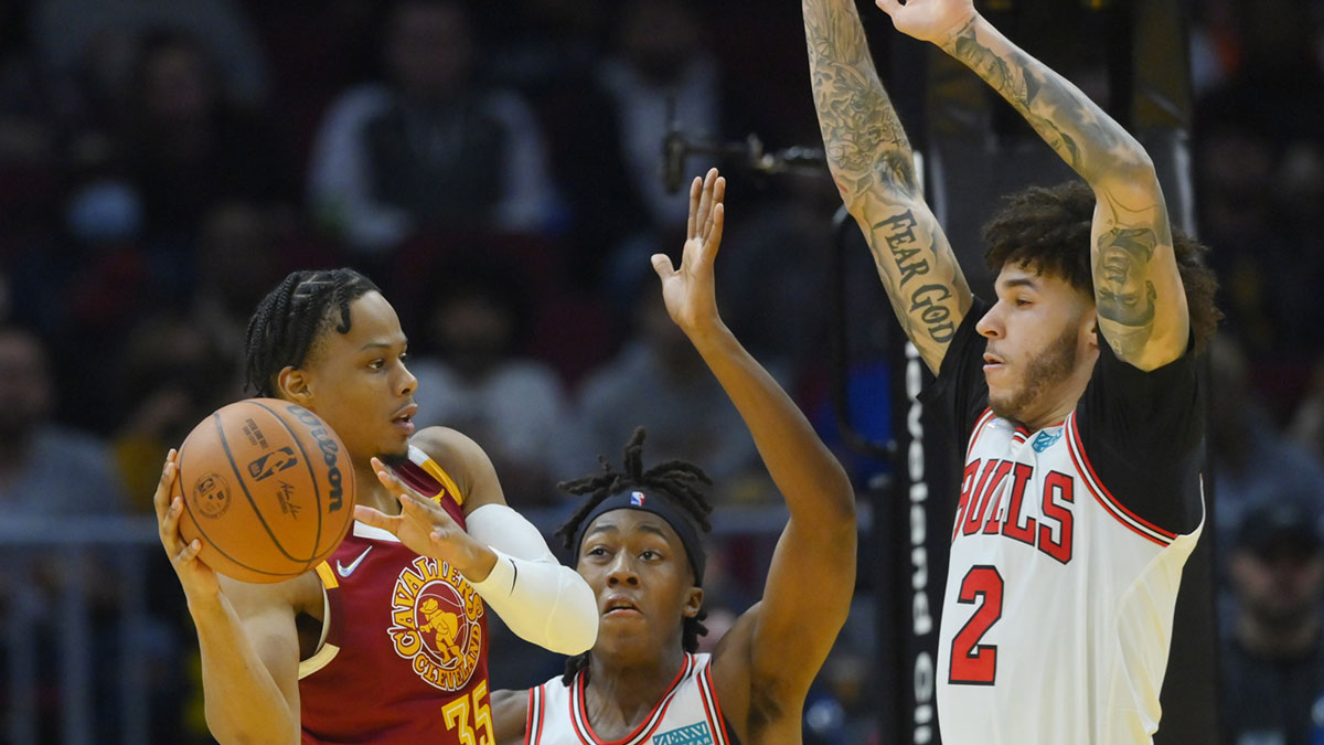 Chicago Bulls guard Ayo Dosunmu (12) and guard Lonzo Ball (2) defend Cleveland Cavaliers forward Isaac Okoro (35) in the third quarter at Rocket Mortgage FieldHouse.
