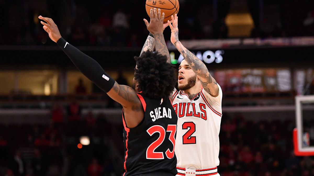 Chicago Bulls forward Lonzo Ball (2) hits a three point shot against Toronto Raptors guard Jamal Shead (23) during overtime at the United Center.