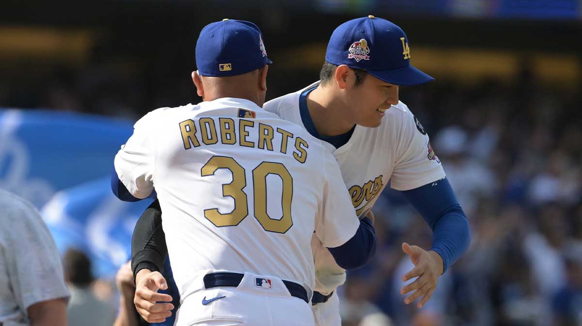 Los Angeles Dodgers two-way player Shohei Ohtani (17) reacts with manager Dave Roberts (30) before the game against the Detroit Tigers at Dodger Stadium.