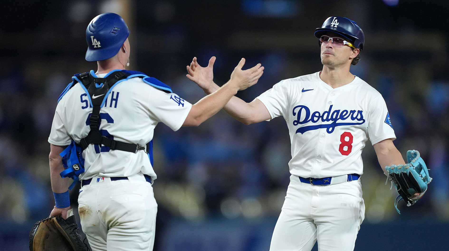 Los Angeles Dodgers first baseman Kike Hernandez (8) is congratulated by catcher Will Smith (16) after pitching the final out in the ninth inning against the Miami Marlins at Dodger Stadium.