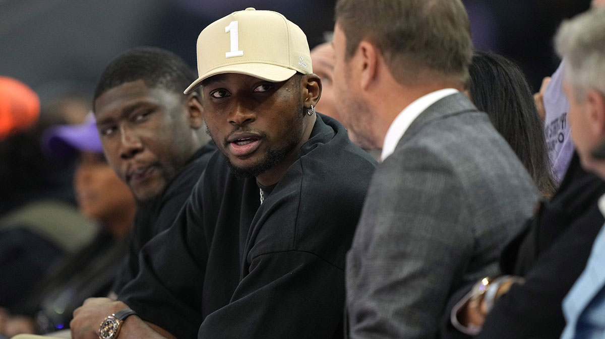 Golden State Warriors forward Jonathan Kuminga (center left) talks with owner Joe Lacob (center right) during the second quarter of the game between the Golden State Valkyries and the Los Angeles Sparks at Chase Center.