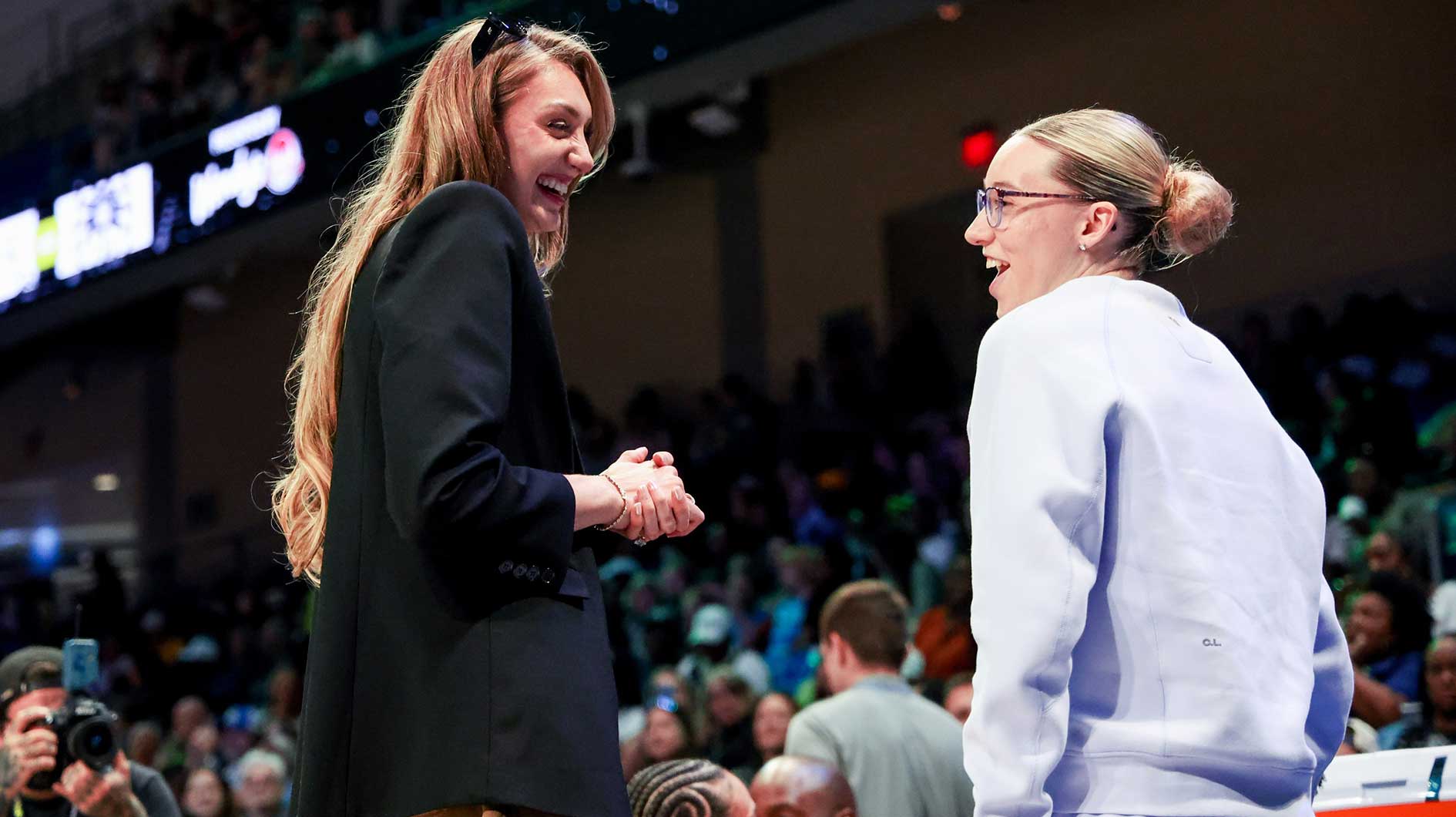 Los Angeles Sparks forward Cameron Brink (left) speaks with Dallas Wings guard Paige Bueckers (right) before the game at College Park Center.