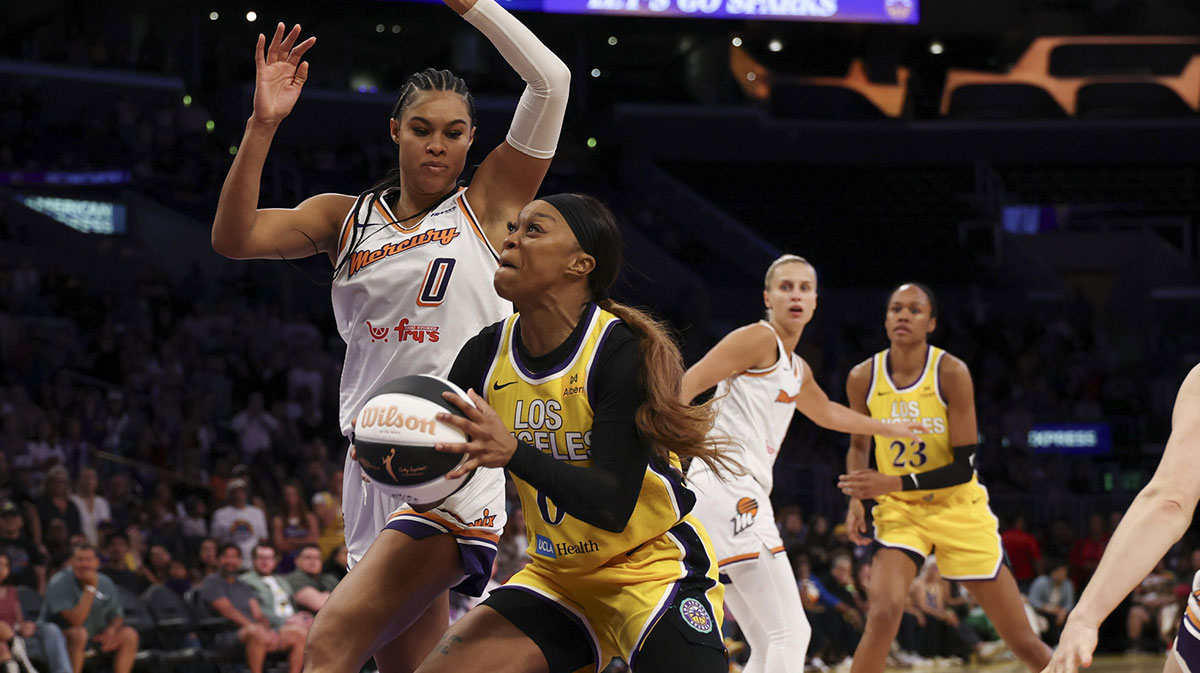Los Angeles Sparks guard Odyssey Sims (0) drives to the basket against Phoenix Mercury forward Satou Sabally (0) during the fourth quarter at Crypto.com Arena.