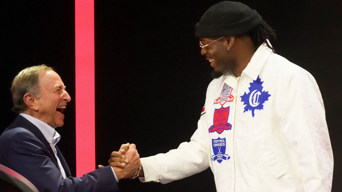 Oklahoma City Thunder guard Luguentz Dort shakes hands with NHL Commissioner Gary Bettman as he announces a trade by the Montreal Canadiens for the 16th overall pick with New York Islanders in the first round of the 2025 NHL Draft at Peacock Theater